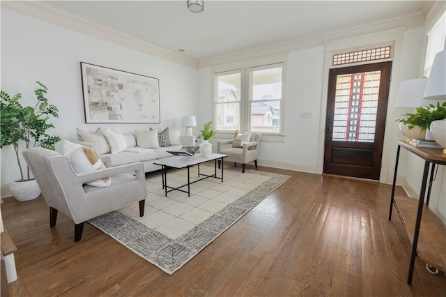 living room featuring wood finished floors, baseboards, plenty of natural light, and ornamental molding