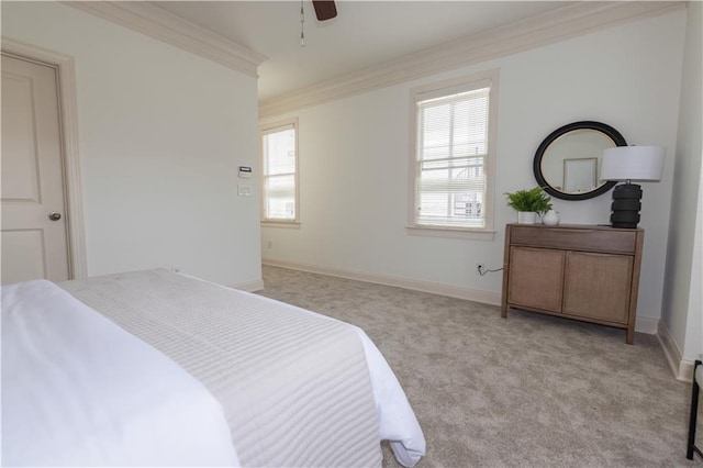 bedroom with baseboards, light carpet, a ceiling fan, and crown molding