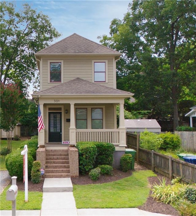 view of front of property with a front yard and a porch