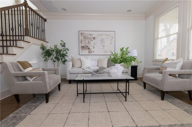 living room featuring wood finished floors, stairway, baseboards, and ornamental molding