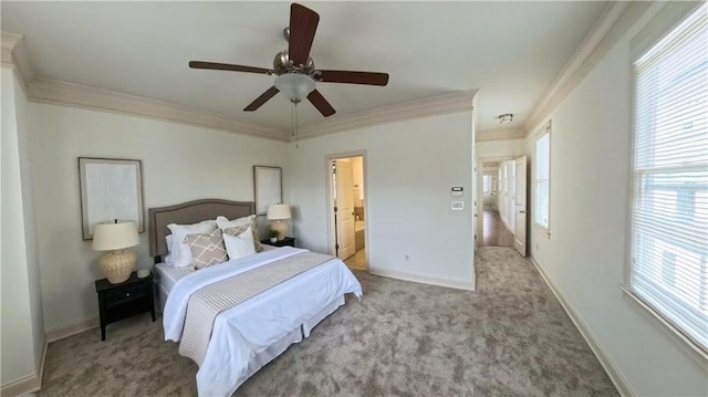 bedroom with connected bathroom, baseboards, carpet flooring, and crown molding