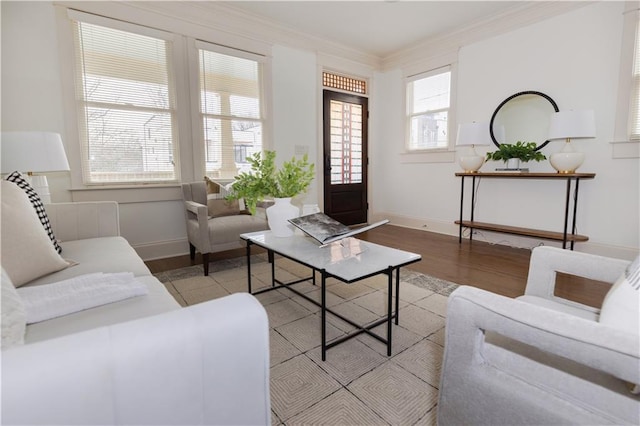 living room with ornamental molding, baseboards, and wood finished floors