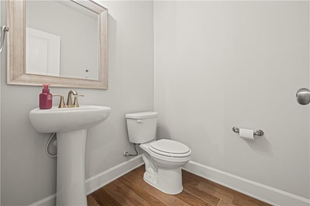 bathroom with sink, hardwood / wood-style flooring, and toilet