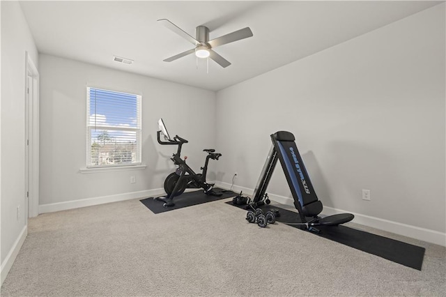 workout room with light carpet and ceiling fan