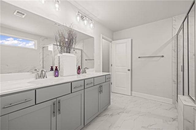 bathroom featuring a shower with door and vanity