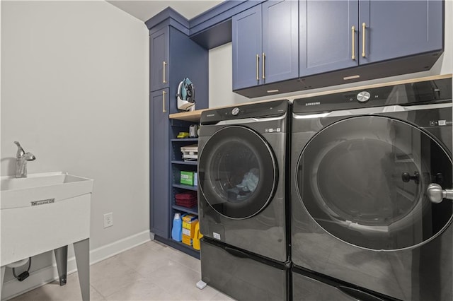 clothes washing area featuring cabinets, light tile patterned flooring, and independent washer and dryer