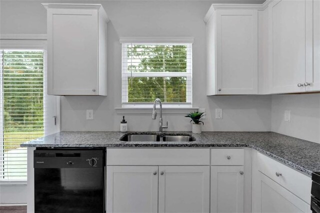 kitchen featuring a wealth of natural light, dishwasher, sink, and white cabinets