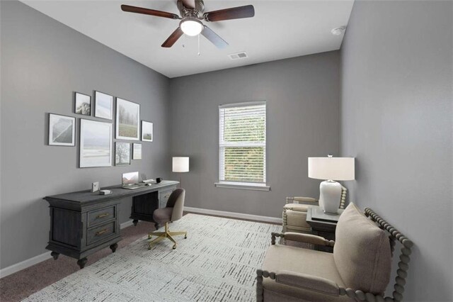 office area featuring ceiling fan and light colored carpet