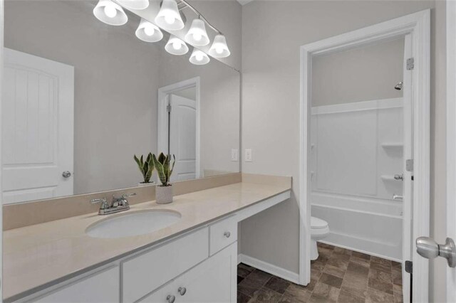 full bathroom featuring tub / shower combination, vanity, and toilet