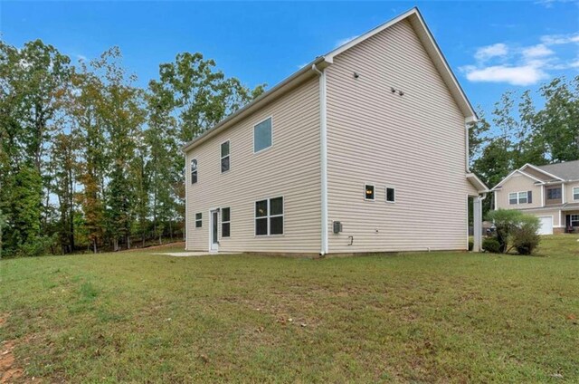 rear view of property with a lawn