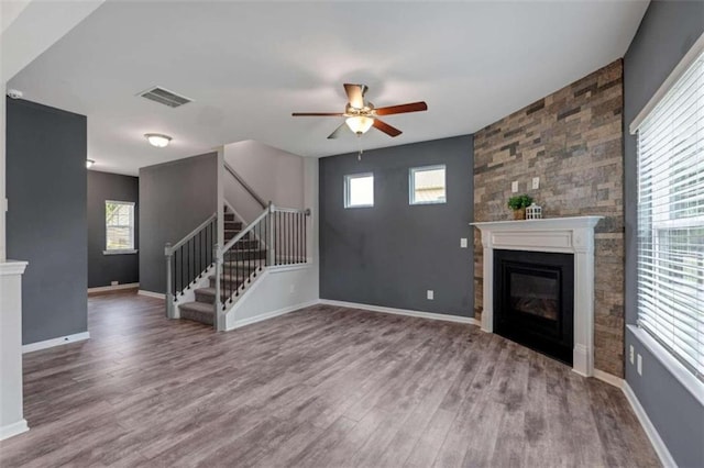 unfurnished living room featuring wood-type flooring and ceiling fan