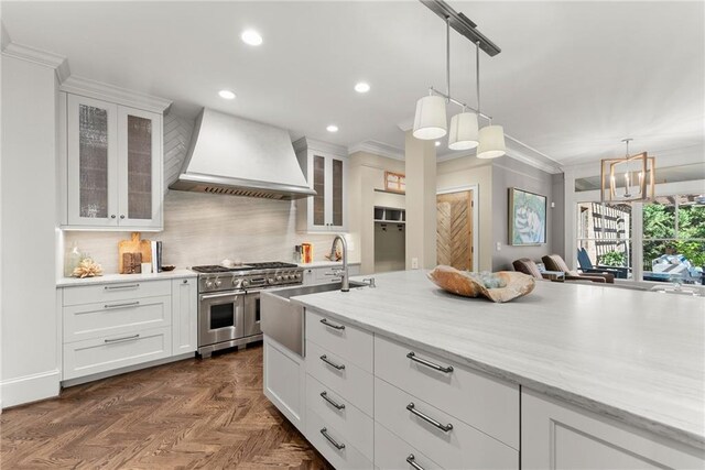 1539 Berkeley Ct, Gainesville, GA 30501 - kitchen with custom range hood, range with two ovens, white cabinetry, recessed lighting, and ornamental molding