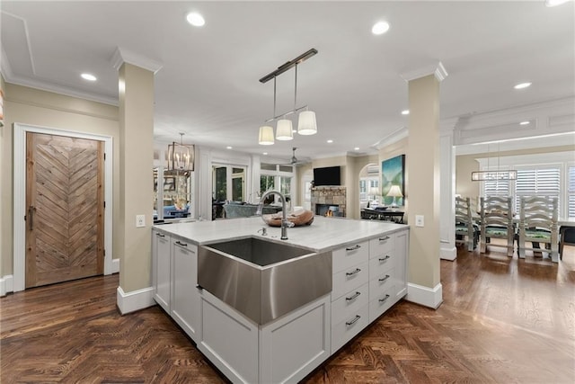 1539 Berkeley Ct, Gainesville, GA 30501 - kitchen with a sink, crown molding, baseboards, open floor plan, and recessed lighting