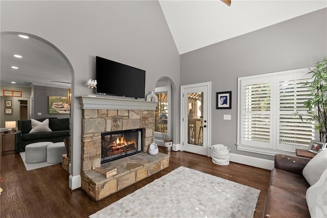 1539 Berkeley Ct, Gainesville, GA 30501 - living area with arched walkways, a fireplace, wood finished floors, high vaulted ceiling, and baseboards