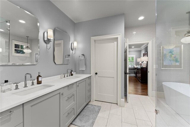 1539 Berkeley Ct, Gainesville, GA 30501 - ensuite bathroom with a freestanding tub, double vanity, recessed lighting, a shower, and baseboards