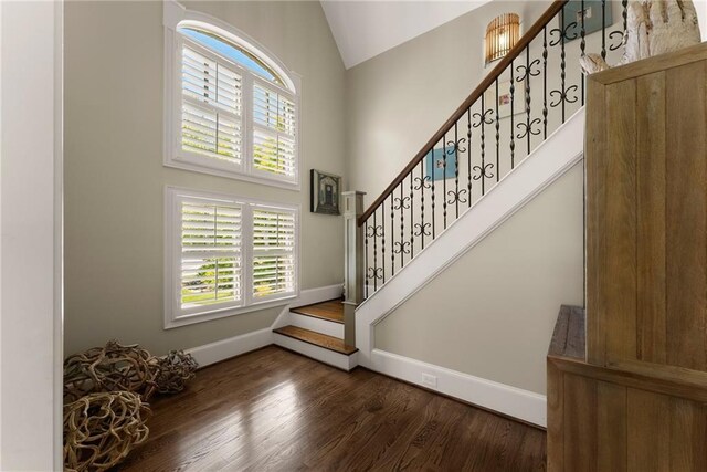 1539 Berkeley Ct, Gainesville, GA 30501 - entrance foyer featuring plenty of natural light, baseboards, stairway, wood finished floors, and high vaulted ceiling