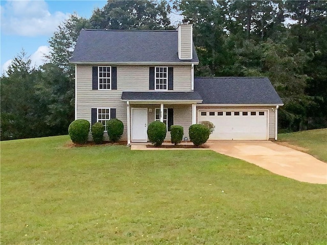 colonial inspired home with a garage and a front lawn