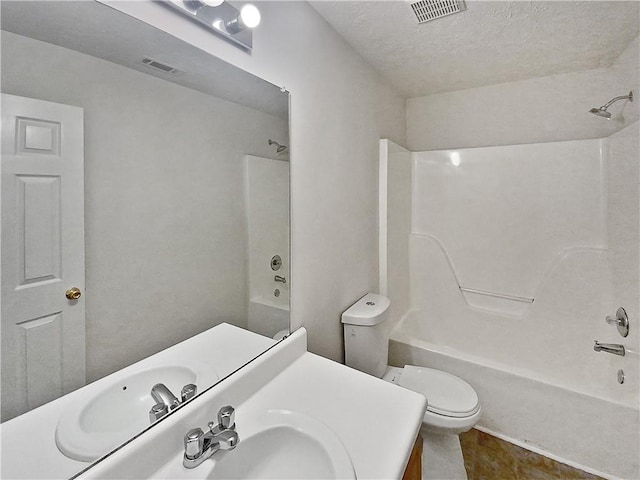 full bathroom with a textured ceiling,  shower combination, vanity, and toilet