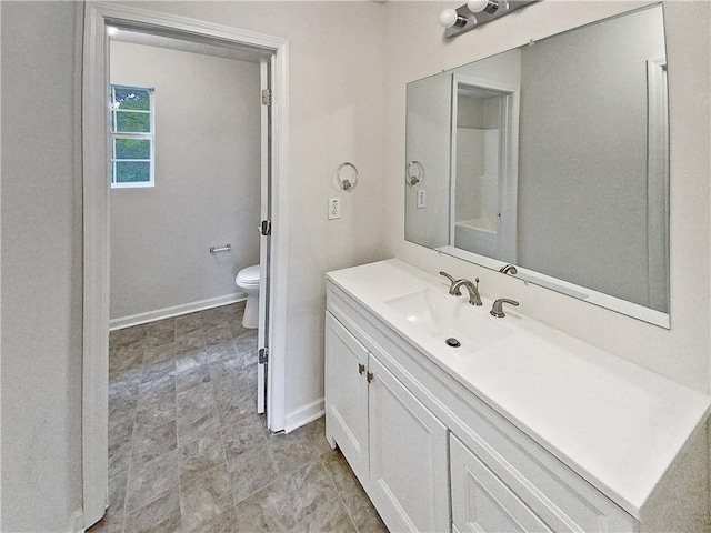 bathroom featuring vanity and toilet