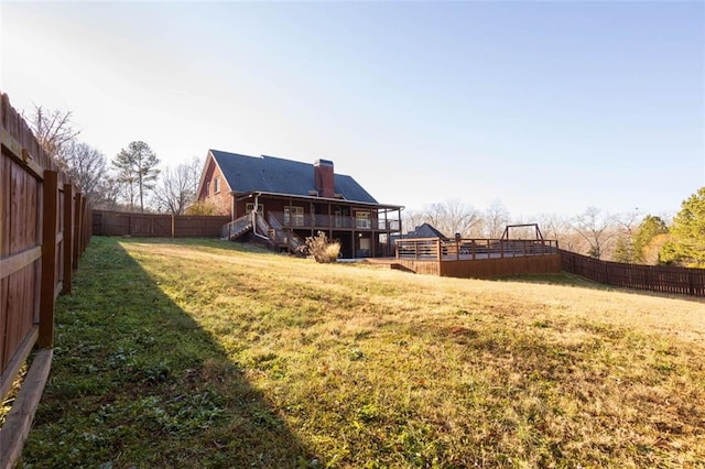 view of yard featuring a fenced backyard and a deck