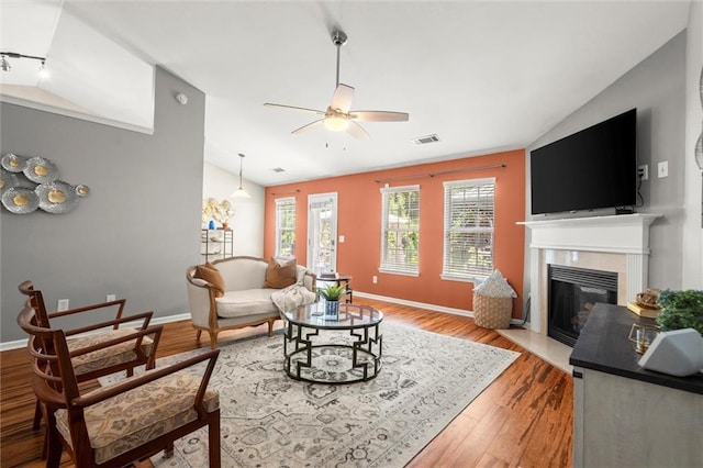 2125 Mina Lane Dr, Buford, GA 30518 - living room with lofted ceiling, ceiling fan, a fireplace with flush hearth, light wood-style floors, and baseboards
