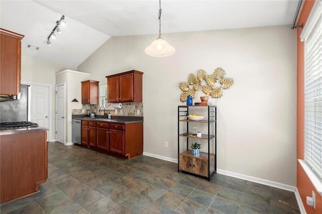2125 Mina Lane Dr, Buford, GA 30518 - kitchen featuring dark countertops, rail lighting, baseboards, backsplash, and lofted ceiling