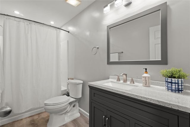 2125 Mina Lane Dr, Buford, GA 30518 - bathroom with wood finished floors, vanity, toilet, shower / bath combo with shower curtain, and recessed lighting