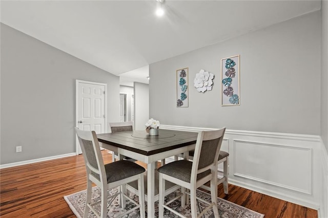 2125 Mina Lane Dr, Buford, GA 30518 - dining space with wood finished floors, vaulted ceiling, and a wainscoted wall