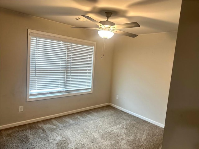 spare room featuring carpet, baseboards, and a ceiling fan