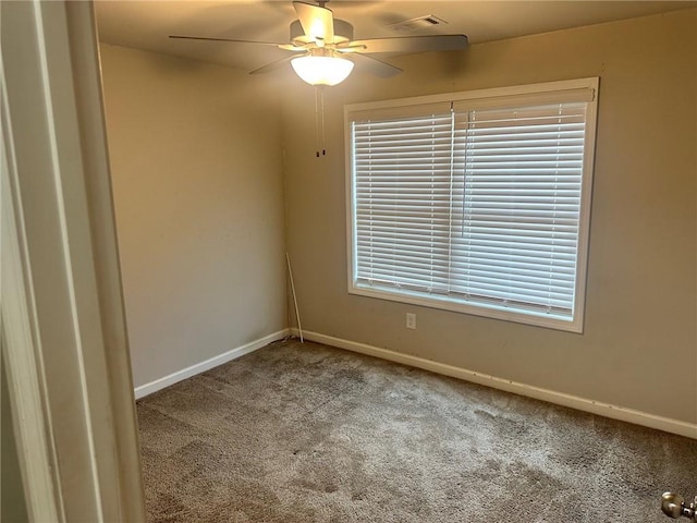 empty room with carpet, baseboards, and a ceiling fan