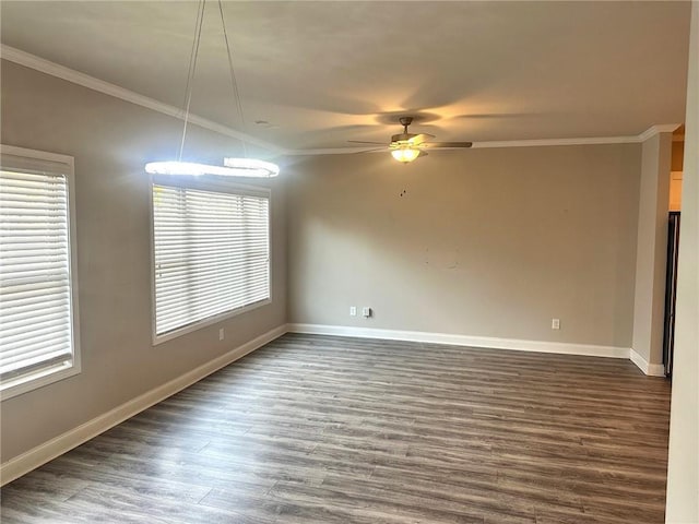 empty room featuring dark wood-style floors, ceiling fan, baseboards, and crown molding