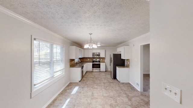 3359 Mansfield Ln, Snellville, GA 30039 - kitchen with decorative backsplash, appliances with stainless steel finishes, a notable chandelier, white cabinets, and a sink