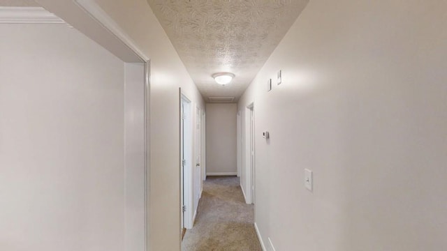 3359 Mansfield Ln, Snellville, GA 30039 - hallway featuring a textured ceiling, baseboards, and light carpet