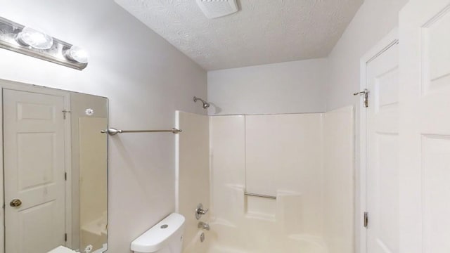 3359 Mansfield Ln, Snellville, GA 30039 - bathroom featuring visible vents, a textured ceiling, toilet, and washtub / shower combination
