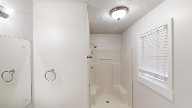 3359 Mansfield Ln, Snellville, GA 30039 - full bathroom featuring a shower and a textured ceiling