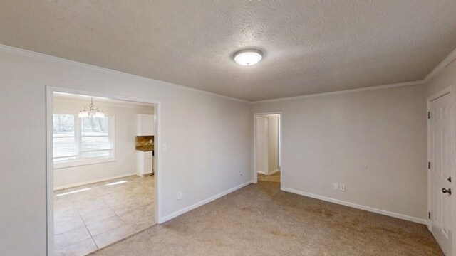 3359 Mansfield Ln, Snellville, GA 30039 - unfurnished room featuring baseboards, a chandelier, ornamental molding, light carpet, and a textured ceiling