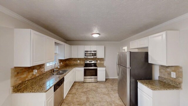 3359 Mansfield Ln, Snellville, GA 30039 - kitchen featuring white cabinets, tasteful backsplash, appliances with stainless steel finishes, and a sink