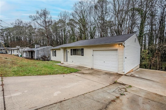 ranch-style house with concrete driveway, a garage, and a front yard