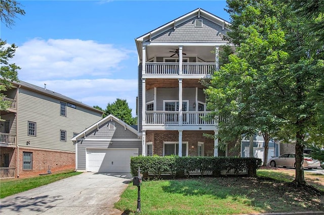 view of front of home featuring ceiling fan, a front lawn, a balcony, and a garage