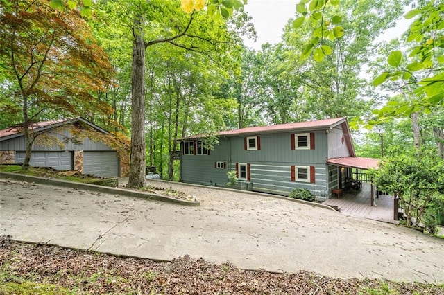 193 Alm Ln, Ellijay, GA 30540 - view of front of house featuring a garage, an outdoor structure, and a wooden deck