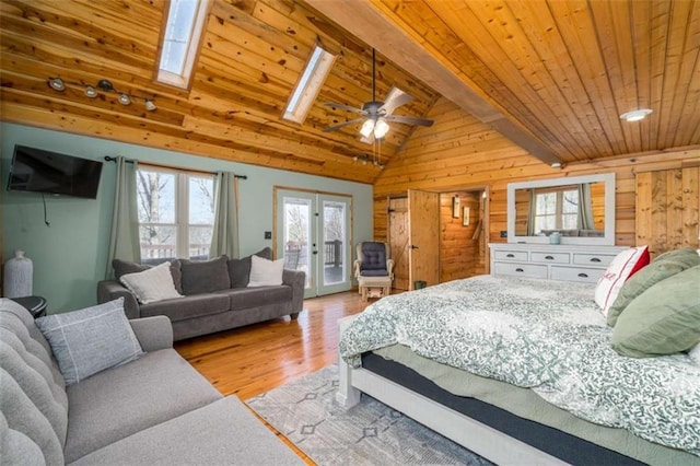 193 Alm Ln, Ellijay, GA 30540 - bedroom featuring access to exterior, multiple windows, wood finished floors, wood walls, and a skylight