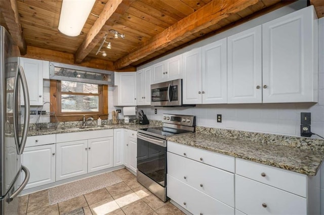 193 Alm Ln, Ellijay, GA 30540 - kitchen with appliances with stainless steel finishes, wooden ceiling with exposed beams, white cabinetry, a sink, and light stone counters