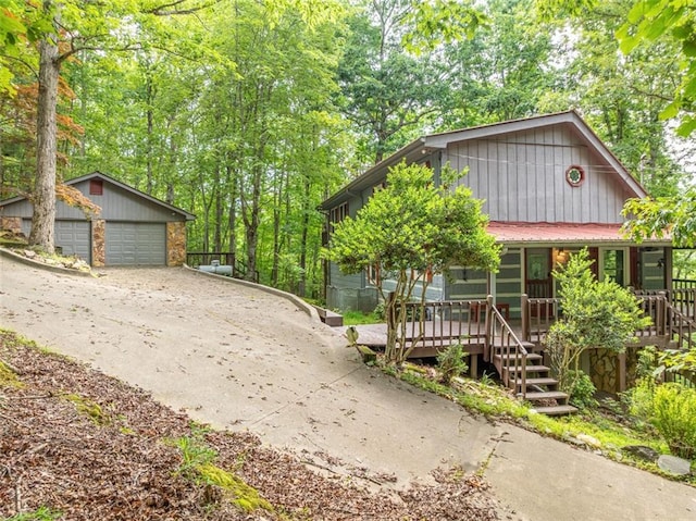 193 Alm Ln, Ellijay, GA 30540 - view of front of property featuring covered porch, an outbuilding, a garage, and stairway