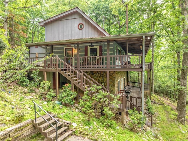 193 Alm Ln, Ellijay, GA 30540 - rustic home with stairway, stone siding, a wooden deck, and a view of trees