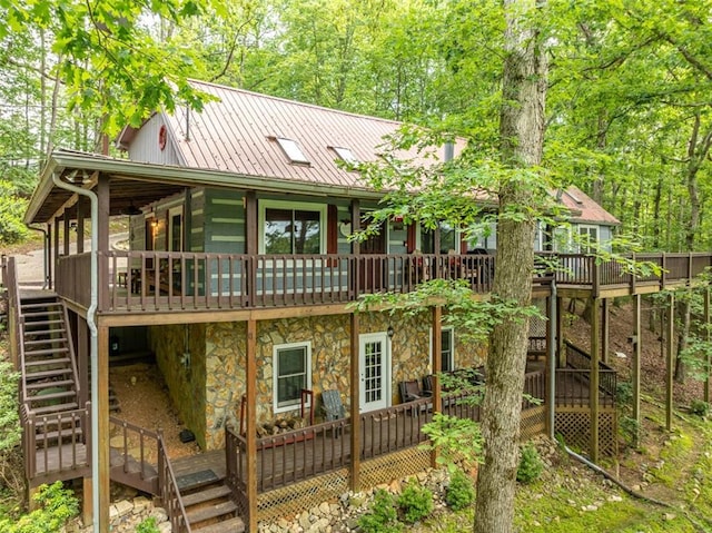 193 Alm Ln, Ellijay, GA 30540 - rear view of house with stairs, stone siding, a deck, and metal roof