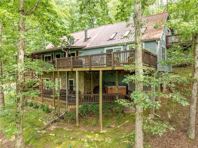 193 Alm Ln, Ellijay, GA 30540 - back of property with a hot tub, a wooden deck, and stone siding