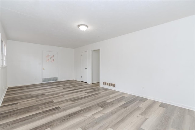 spare room featuring light hardwood / wood-style floors