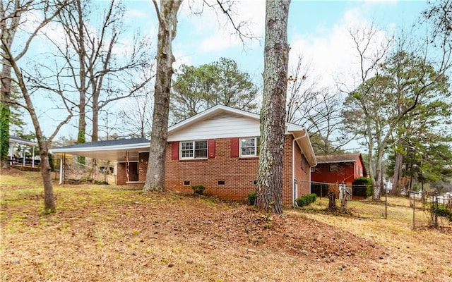 back of house featuring a carport