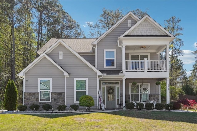 2860 Windsor Knoll Dr, Dacula, GA 30019 - craftsman house featuring a balcony, stone siding, a porch, and a front yard