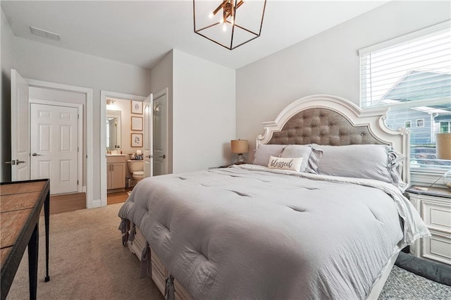 2860 Windsor Knoll Dr, Dacula, GA 30019 - bedroom with light colored carpet, ensuite bath, and a chandelier